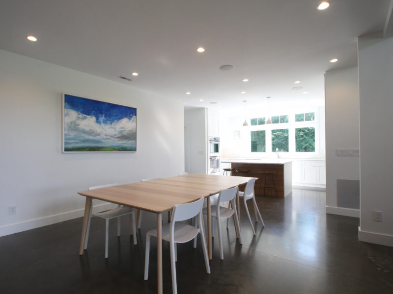 Open concept dining room and kitchen with polished concrete floor